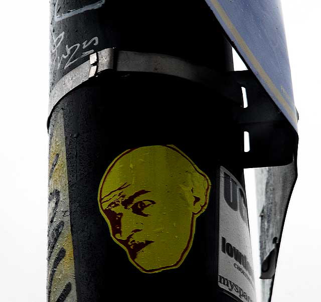 Sticker on pole, Sunset Boulevard in Hollywood - Yellow Face
