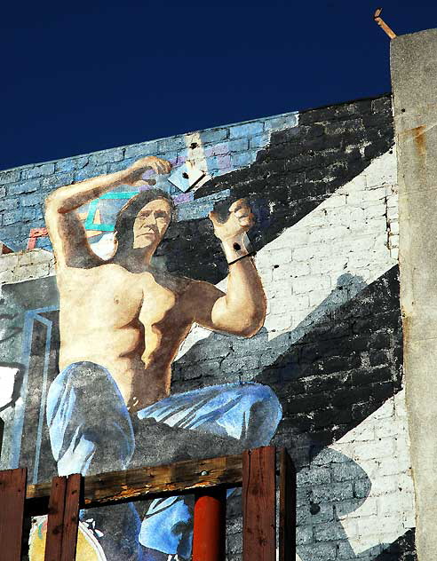 Trompe l'oeil worker painted on brick wall, North La Brea at First Street
