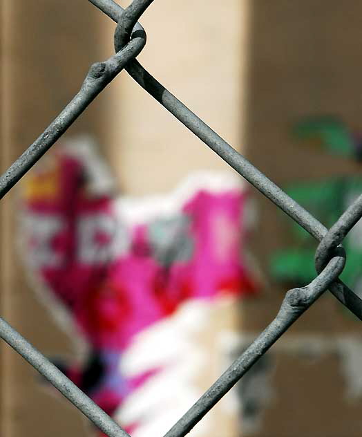 Torn poster behind chain link fence, Sunset Boulevard, Hollywood