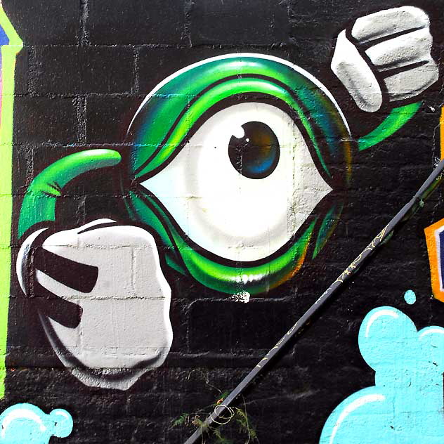 One-eyed zygote (with gloves) - graffiti wall in alley behind Melrose Avenue 