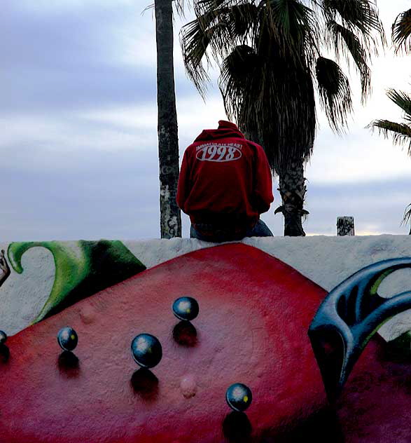 Tagger sitting on wall, Venice Beach