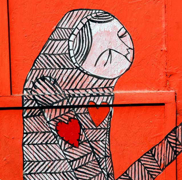 Figure with heart on sleeve - orange plywood wall at Heliotrope and Melrose, just south of LA City College