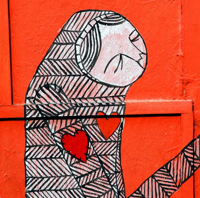 Figure with heart on sleeve - orange plywood wall at Heliotrope and Melrose, just south of LA City College