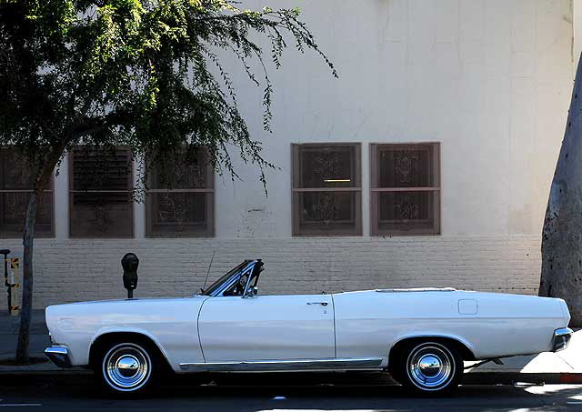 1967 pearl white Mercury Comet Caliente convertible, with fuzzy dice, parked on Selma in Hollywood