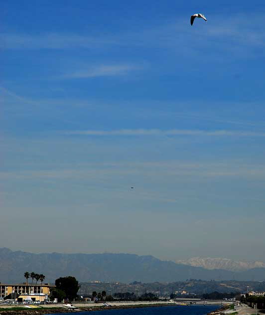 From the bridge over the mole at Playa Del Rey, Hollywood in the mid-range, and the snow-covered San Bernardino Mountains in the far distance