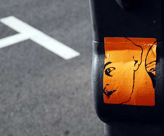 Orange "face" sticker on parking meter, Melrose Avenue at Edinburgh, west of Fairfax