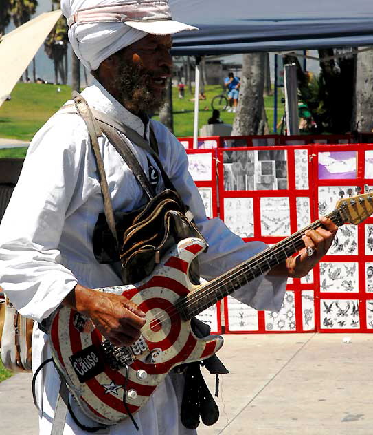 The man in a turban on roller-skates who scoots around playing his guitar right in your face in Venice Beach