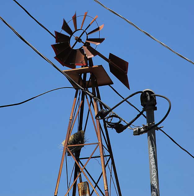 Windmill with broom above motorcycle repair shop, alley behind Melrose Avenue