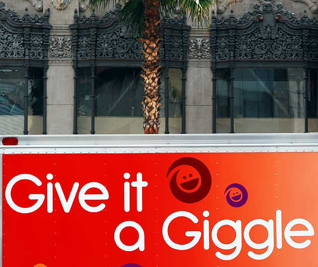 Give it a Giggle - truck passing the El Capitan Theater on Hollywood Boulevard