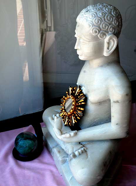 Buddha and mirror in shop window, Sunset Boulevard at Sierra Bonita