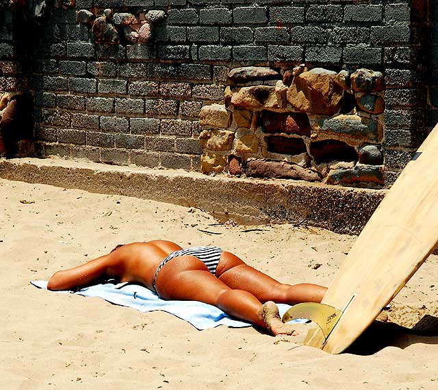 Topless sunbather at "The Wall" at Surfrider Beach, Malibu