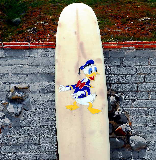 Donald Duck surfboard at "The Wall" at Surfrider Beach, Malibu