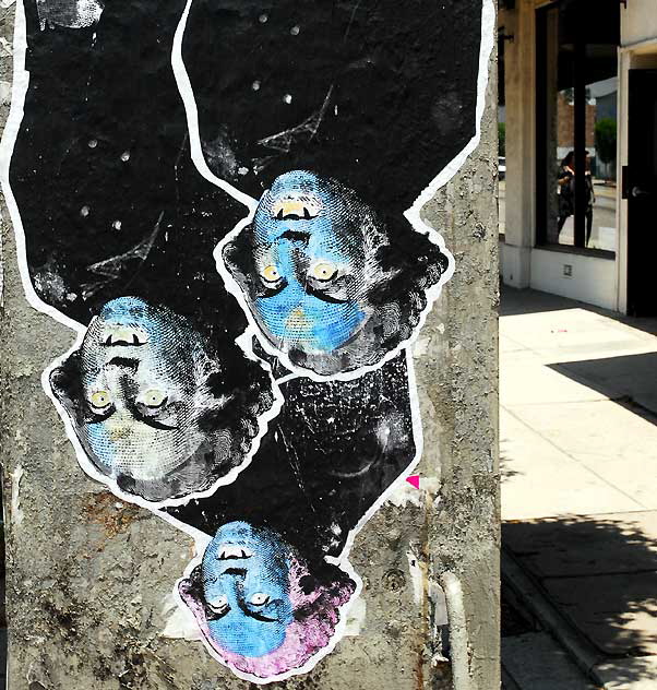 Three upside-down bat men on utility box - La Brea north of Wilshire 