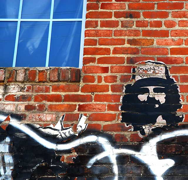 Blue Window, Face on Red Brick Wall