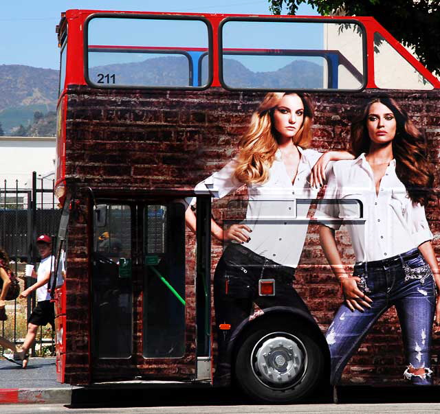 Tour bus near Hollywood and Vine with "wrap" graphic for Express Jeans
