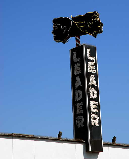 Neon faces above "Leader" - Fairfax Avenue