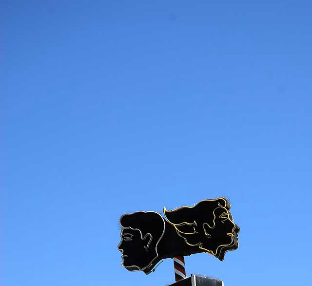 Neon faces above "Leader" - Fairfax Avenue