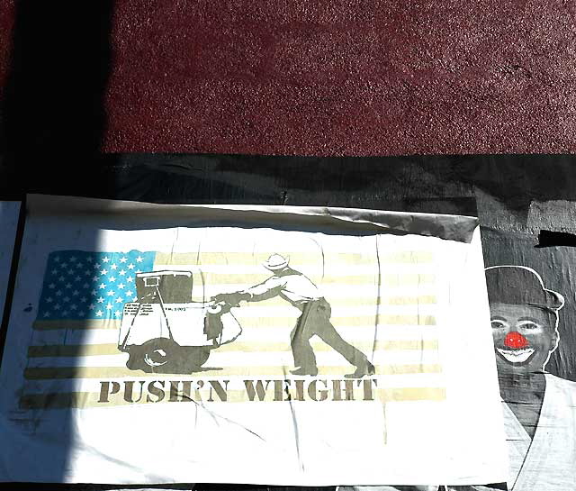 "Pushing Weight" and Clown, graphics on a red wall on Fairfax Avenue