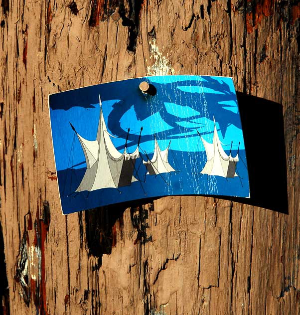 Art card nailed to telephone pole - medieval tournament tents 