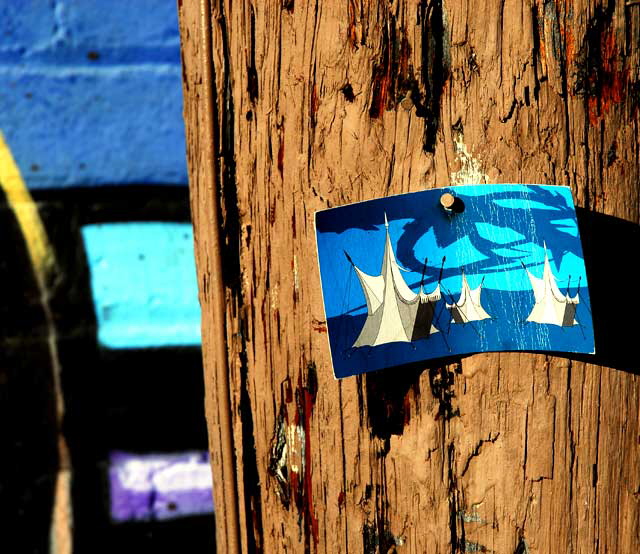Art card nailed to telephone pole - medieval tournament tents 
