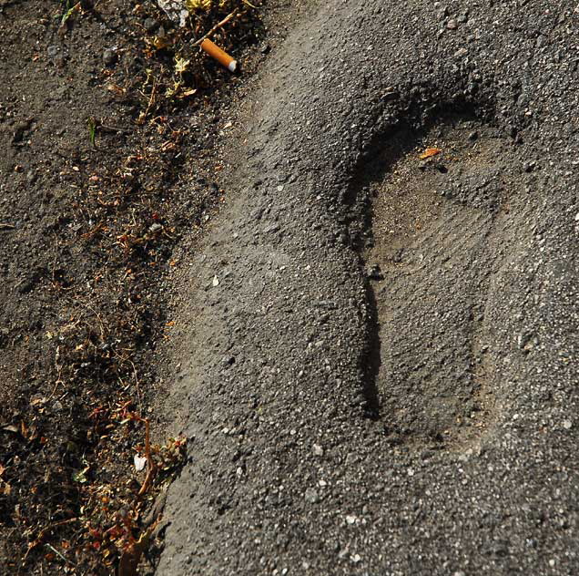 Footprint in asphalt, Hollywood sidewalk