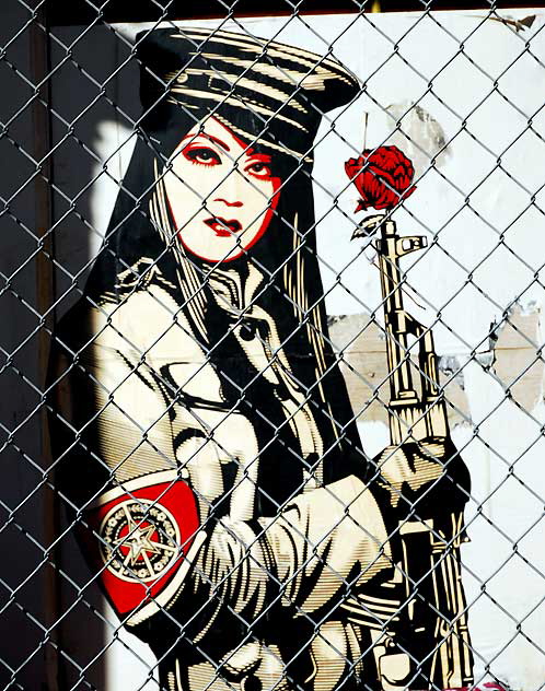 Shepard Fairey "Obey" graphic behind a chain-link fence at an abandoned restaurant, Sunset Boulevard at Gordon, Friday, February 11, 2011