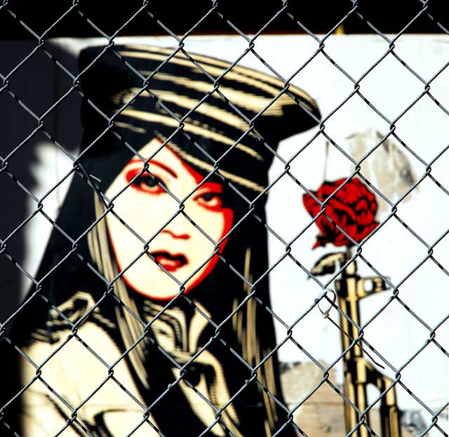 Shepard Fairey "Obey" graphic behind a chain-link fence at an abandoned restaurant, Sunset Boulevard at Gordon, Friday, February 11, 2011