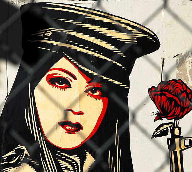 Shepard Fairey "Obey" graphic behind a chain-link fence at an abandoned restaurant, Sunset Boulevard at Gordon, Friday, February 11, 2011