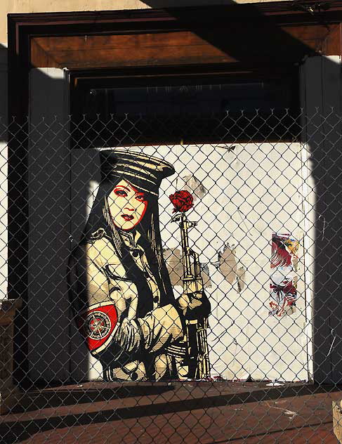 Shepard Fairey "Obey" graphic behind a chain-link fence at an abandoned restaurant, Sunset Boulevard at Gordon, Friday, February 11, 2011