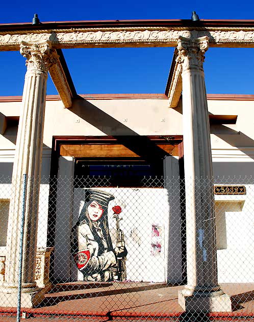 Shepard Fairey "Obey" graphic behind a chain-link fence at an abandoned restaurant, Sunset Boulevard at Gordon, Friday, February 11, 2011