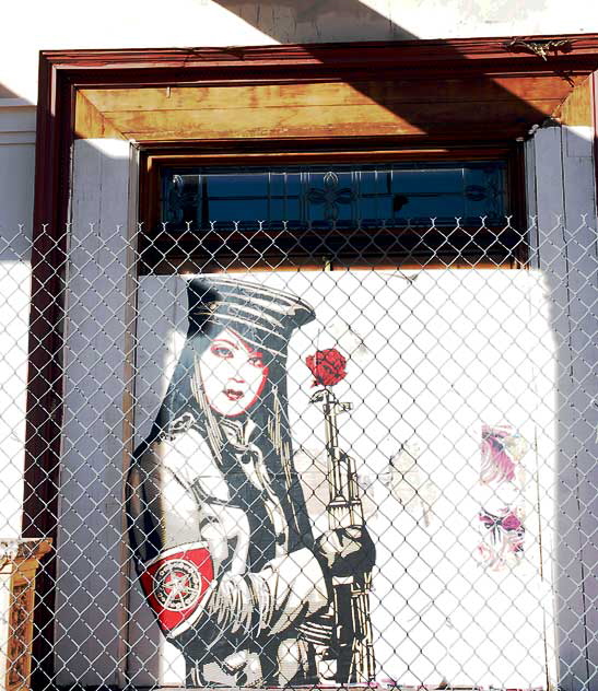 Shepard Fairey "Obey" graphic behind a chain-link fence at an abandoned restaurant, Sunset Boulevard at Gordon, Friday, February 11, 2011