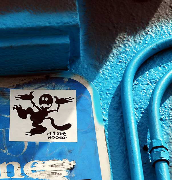Sticker on Blue Wall with Electrical Conduit 