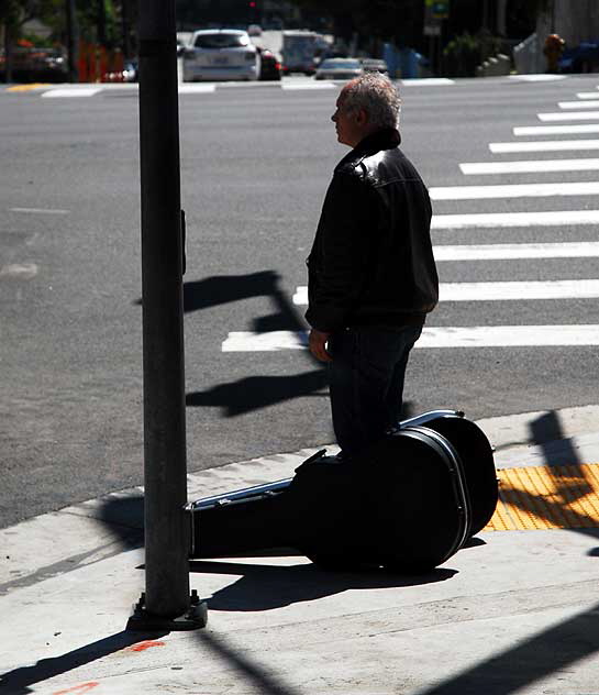 Man with two guitars on the Sunset Strip, Friday, April 1, 2011