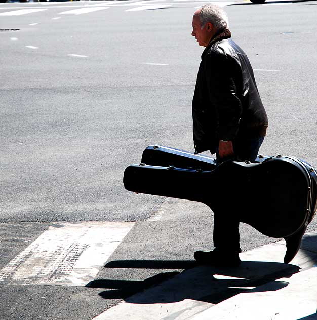 Man with two guitars on the Sunset Strip, Friday, April 1, 2011