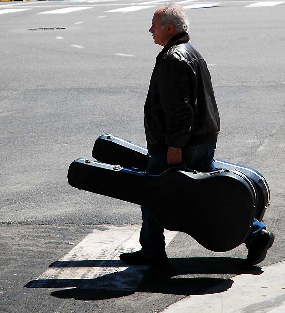Man with two guitars on the Sunset Strip, Friday, April 1, 2011