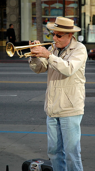 This fellow in front of Hollywood and Highland is, with his boom-box doing the Music Minus One thing, is really ripping into chorus after chorus of Black and Blue.  He is neither.  But he is really good.