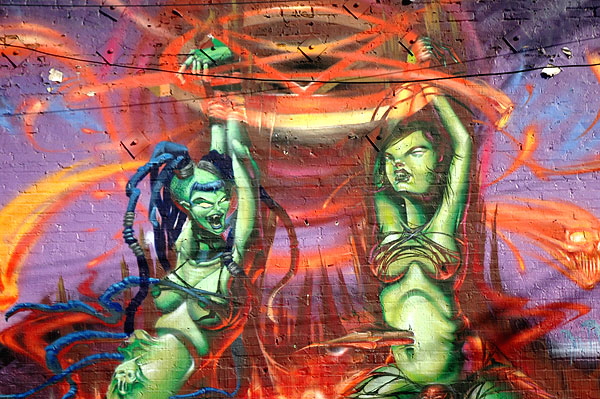 Green graffiti women on wall in an alley off Melrose Avenue 