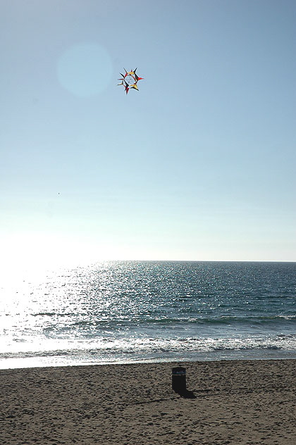 Santa Monic Beach: Lens flair, a very odd kite, the Pacific, the sand, and a trash can 