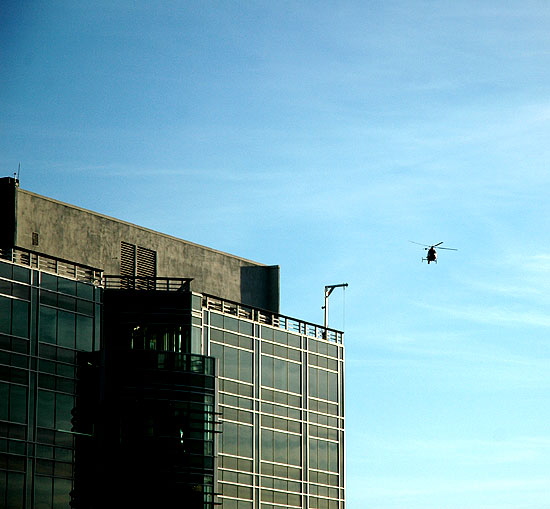 A helicopter passes over the Sunset Strip, on its way to the fires out east -