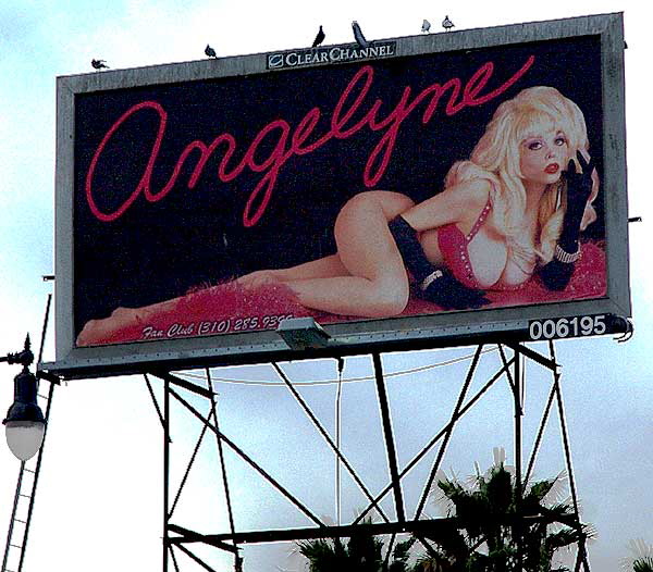Billboard - Angelyne with pigeons on a dark day, Hollywood Boulevard at Cherokee 