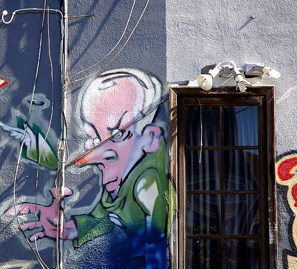 Face at door, graffiti in alley, west side of La Brea Boulevard, south of Willoughby