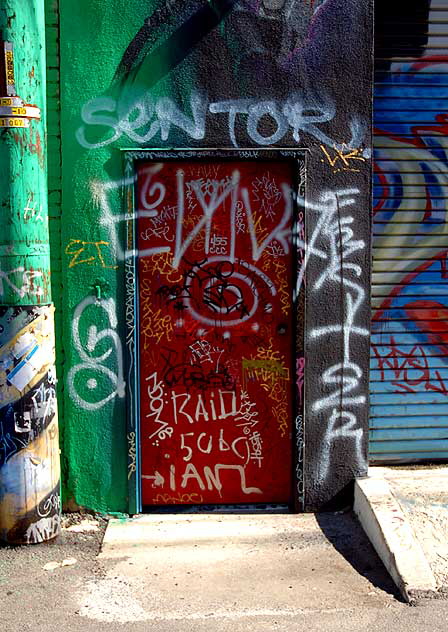 Red door, graffiti in alley, west side of La Brea Boulevard, south of Willoughby