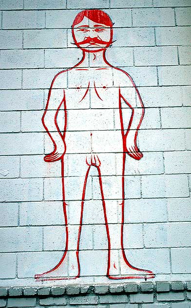A naked man with a mustache on a wall on La Cienega near the freeway