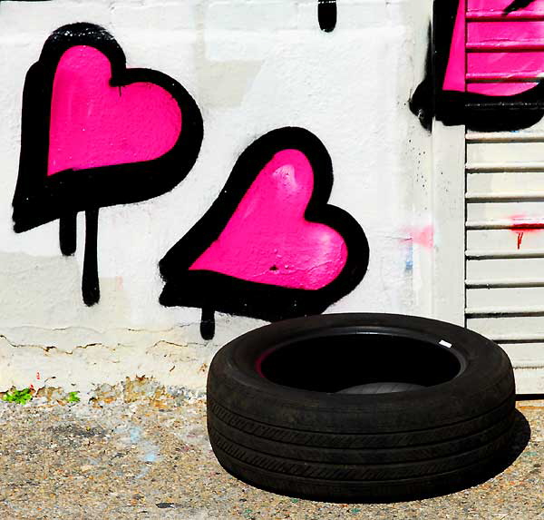 Discarded tire and pink hearts, alley off Melrose Avenue