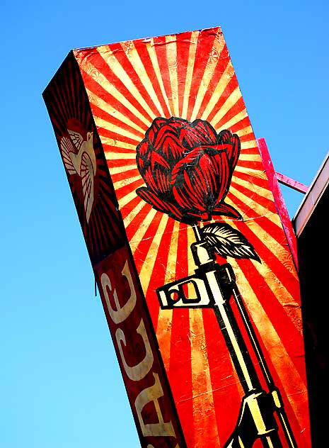 "Peace Dove" and rose in rifle barrel - marquee at restaurant two blocks north of Wilshire, West Los Angeles