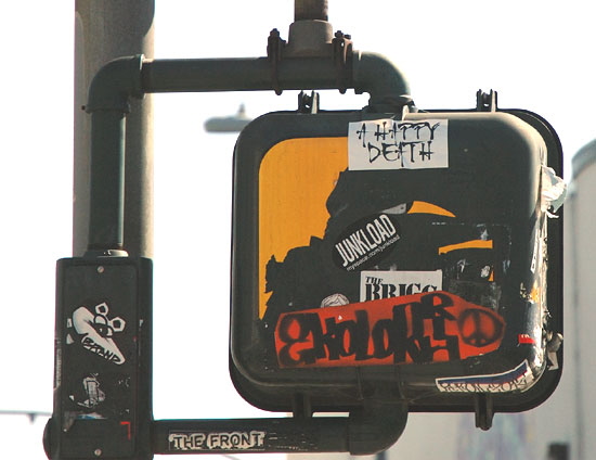 Stickers in traffic signal, Sunset Boulevard at Ivar