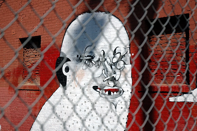 White face, red brick wall, Hollywood Boulevard