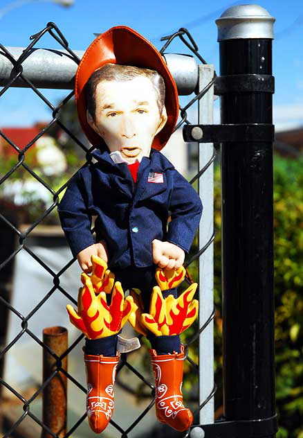 George W. Bush doll on chain link fence, Main Street, Ocean Park