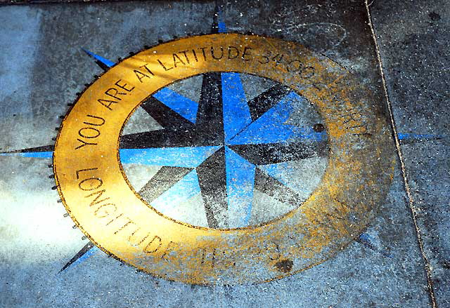 Compass with coordinates in sidewalk in front of a restaurant, Main Street, Ocean Park