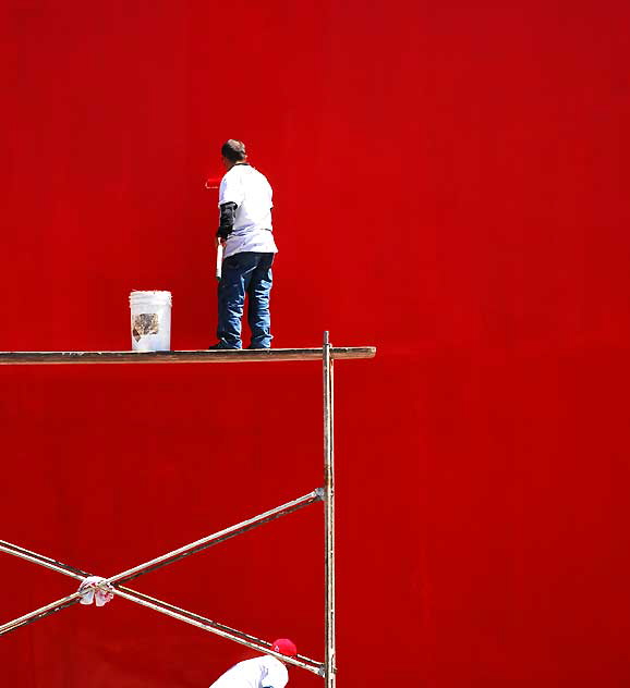 Workers repainting the Geisha House, formerly the Studio Caf, bright red, as it had faded to pink - Hollywood Boulevard at Cherokee